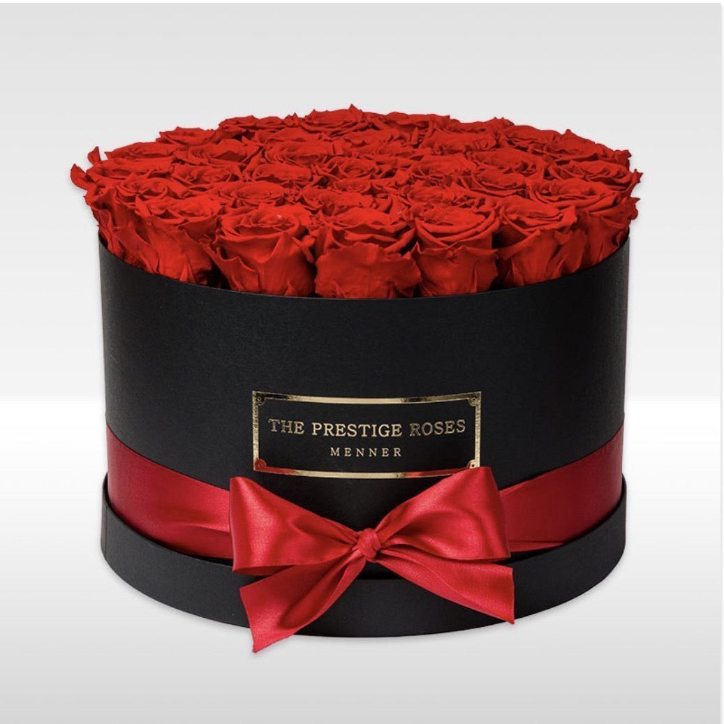 Caja Elite Negra con rosas frescas rojas de alta calidad, presentada en diseño cilíndrico elegante. - The Prestige Roses Madrid