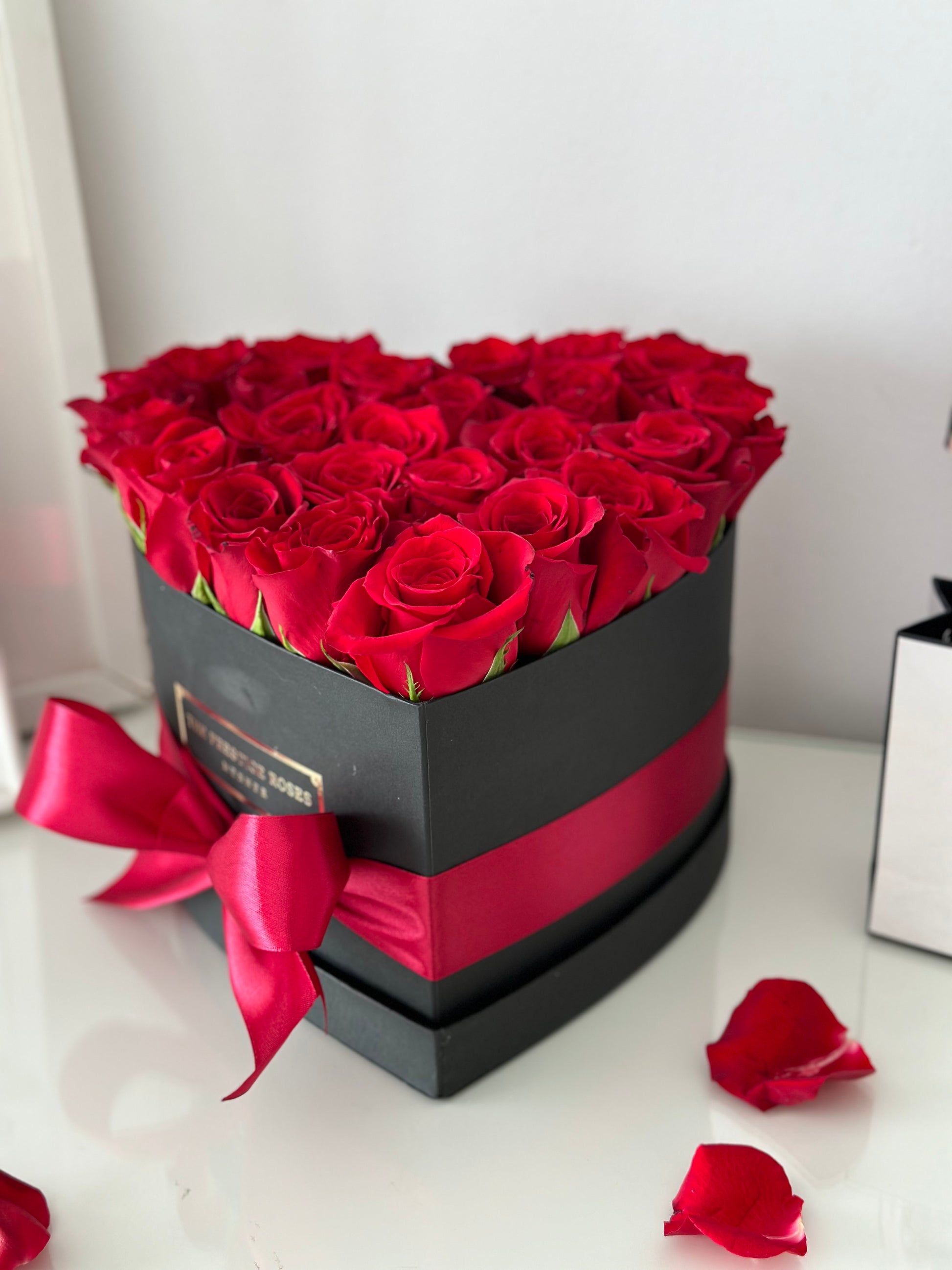 Caja elegante corazón mediana de rosas frescas rojas con presentación de lujo.