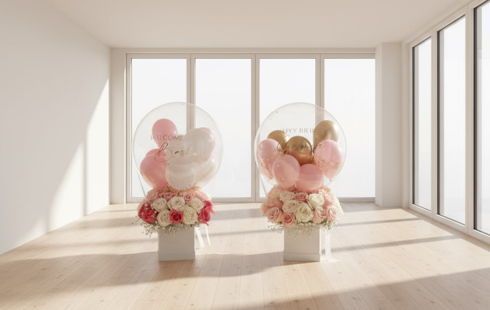 Arreglos florales con globo transparente, rosas en tonos rosa y blanco, mensaje “Welcome Baby”, estilo delicado y elegante para nacimiento o baby shower.