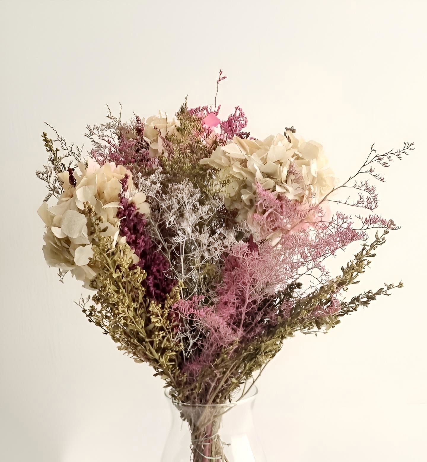 Ramo elegante de flores secas en tonos naturales y rosas, perfecto para decoración de interiores o regalo especial.